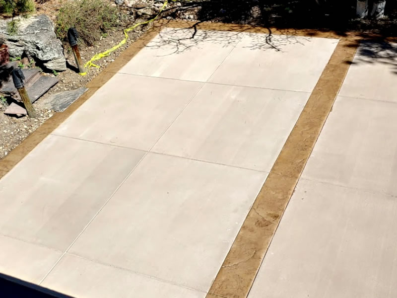 Double driveway partitioned with stamped concrete