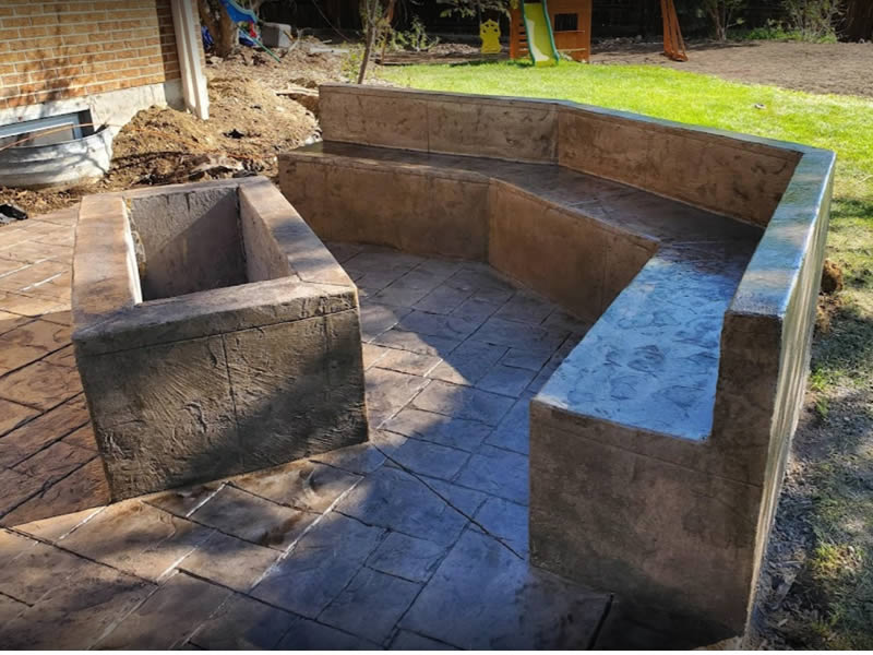 Concrete patio with bench and firepit